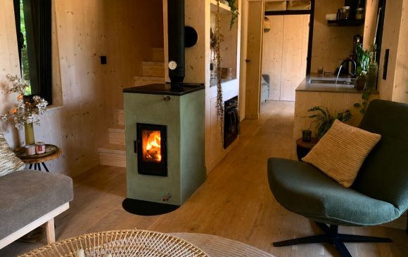 Tiny Rocket stove installed in a tiny house kitchen, beside a staircase to the loft